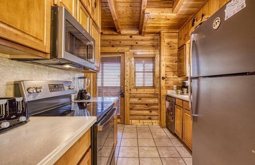 Pigeon Forge House | 1 mile from Pigeon Forge log cabin Townhouse has hot tub with indoor and outdoor pool sleep 8