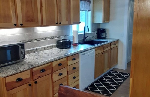 Tawas City House | 4-bedroom home in Tawas City with indoor pool and game room across from L Huron
