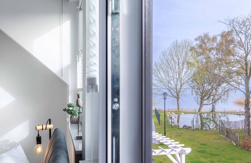 Fuhlendorf House | 5-star vacation home Ostseetraum on the water with fireplace, terrace and Bodden view