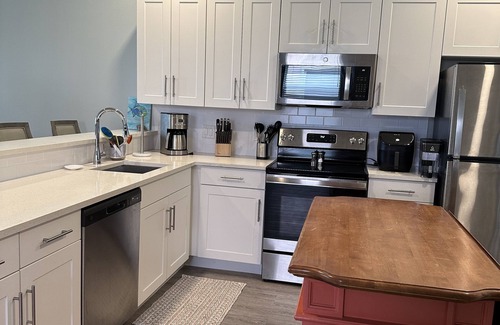Treasure Cay Condo | A beautiful white sand beach, an inviting pool and lush grounds.