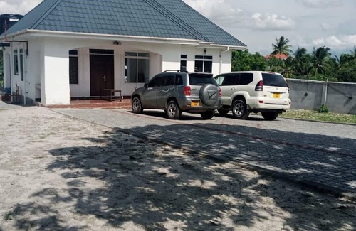 Mbezi House | A Large Bedroomm With Next to the Seating Room