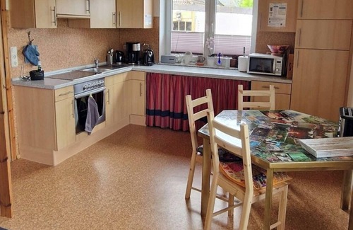 Varel Apartment | Apartment and more . Creative garden with fire pit and barbecue