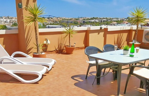 Orihuela Costa Apartment | Apartment with Large Roof Solarium, Pool, Garden, Barbecue, A/C & Wi-Fi
