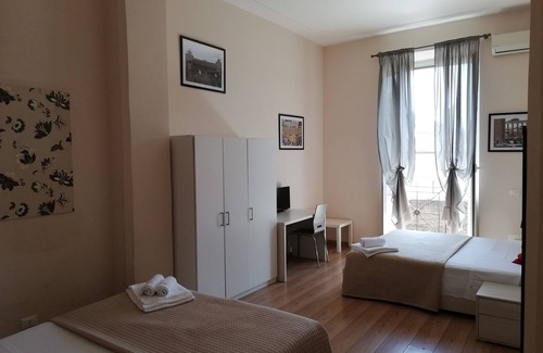 Esquilino Bed & Breakfast | Aria Rome Rooms quadruple room with balcony overlooking Basilica di San Giovanni