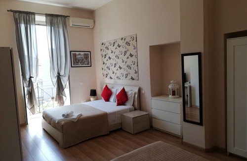 Esquilino Bed & Breakfast | Aria Rome Rooms quadruple room with balcony overlooking Basilica di San Giovanni