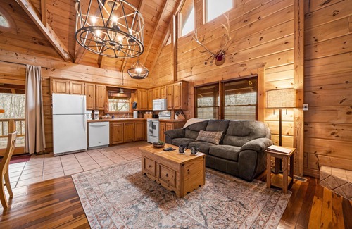 Gatlinburg - Pigeon Forge Cabin | Beautiful cabin nestled among the trees, featuring a loft and relaxing hot tub.