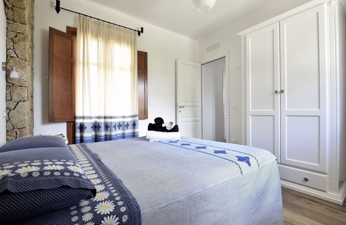 Lotzorai Apartment | Bedroom with double bed, veranda with view