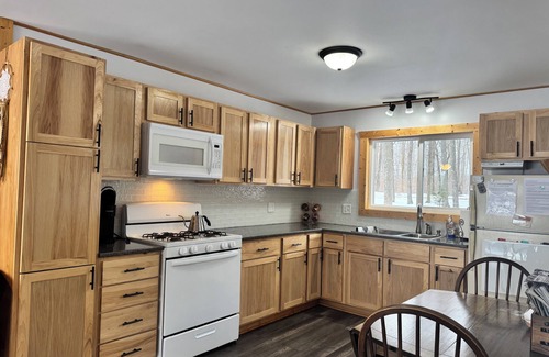 Birchwood House | Charming 2-bedroom cottage with WiFi, AC on quiet lake on trails with kayaks.