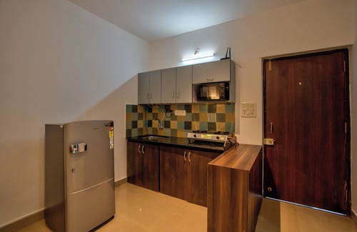 Vagator Apartment | Chic 1BHK Vagator, French Windows in both living room and bedroom.