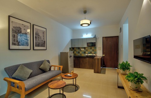 Vagator Apartment | Chic 1BHK Vagator, French Windows in both living room and bedroom.