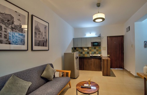 Vagator Apartment | Chic 1BHK Vagator, French Windows in both living room and bedroom.