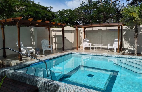 Hastings Apartment | Crotona Garden 2 Bed Apt, Lush and Tropical with Pool. 2 Minutes Walk to Sea