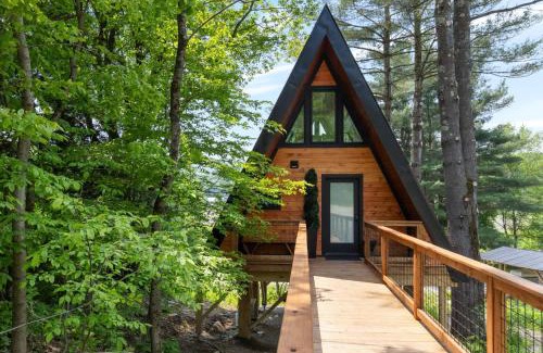 Johnson House | Designer A-Frame Treehouse with hot tub on river
