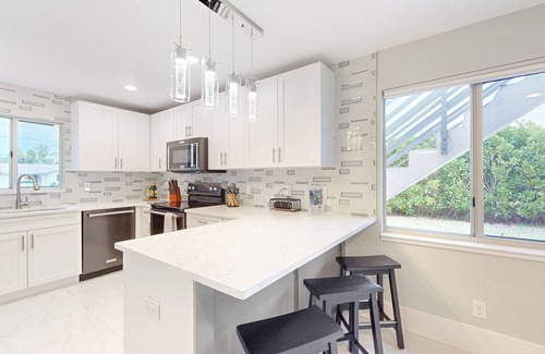 Isles of Capri House | Dog-friendly duplex with a patio, deck, washers, dryers, & central AC