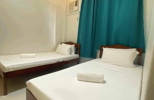 Puerto Princesa City Centre Hotel | Downtown Getaway: Cozy Stay by Miss Sophie's - 3minAirport/1minCapitol/AC/WiFi+