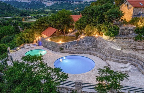 Vrgorac House | Enjoy a wonderful view of the countryside from this inviting vacation home with pool access.