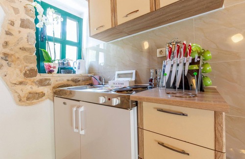 Vrgorac House | Enjoy a wonderful view of the countryside from this inviting vacation home with pool access.