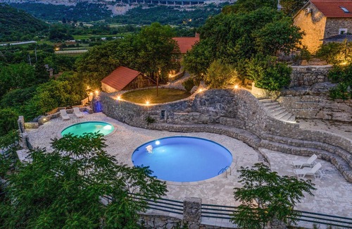 Vrgorac House | Enjoy a wonderful view of the countryside from this inviting vacation home with pool access.