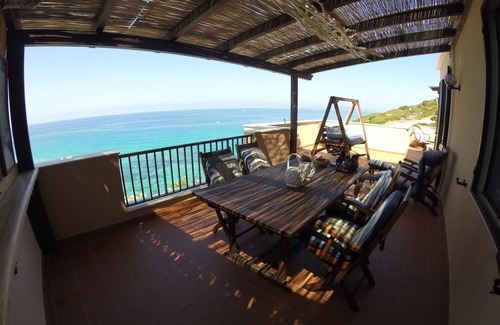 Alghero Apartment | Exclusive penthouse overlooking the sea . with deserted beach under the house.
