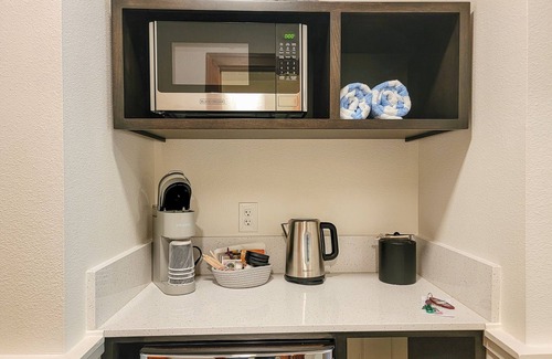 Mazama House | Fir - king bedroom with couch at The Inn At Mazama