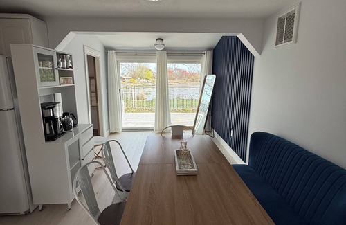 Warwick House | Freshly renovated waterfront retreat in Warwick Cove! This cozy 1-bedroom features a loft-style king bed, queen sleeper sofa, spacious deck, fenced yard, and open backyard leading to the water - perfect for a relaxing coastal escape.