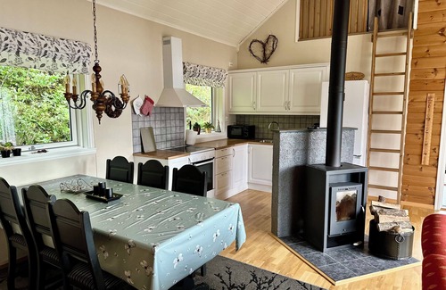 Hareid Cabin | Holiday home with view plot beyond Fjord and mountains.