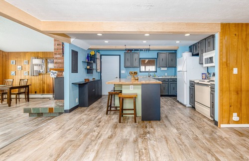 Turnagain House | Inviting home with fireplace, natural light, full kitchen, W/D