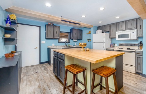 Turnagain House | Inviting home with fireplace, natural light, full kitchen, W/D