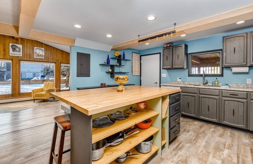 Turnagain House | Inviting home with fireplace, natural light, full kitchen, W/D