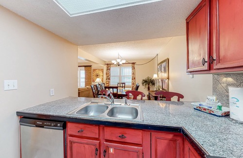 Gulf Shores Condo | Lagoon-front condo with balcony, washer/dryer, shared pool, & dock