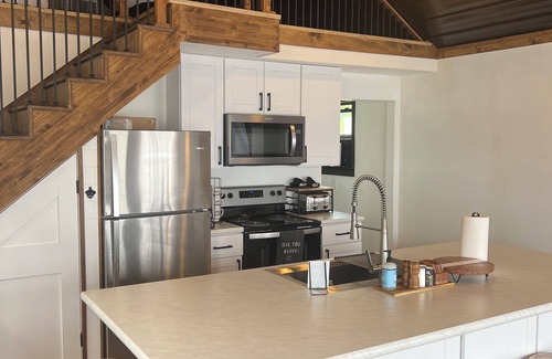 National City Cottage | Lake/beach front property with kayaks, pedal boat, & row boat, near Tawas Bay