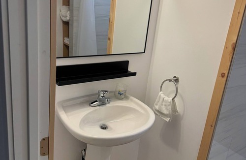 Ottawa Division House | Large bedroom with private bathroom and workspace.