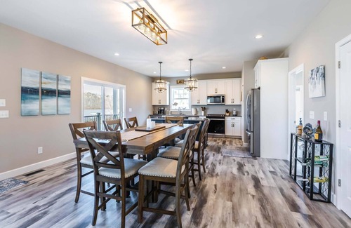 Ingles House | Modern lakefront home with wraparound decks, firepit, and stunning water views on both levels.