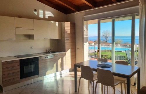 Manerba del Garda Apartment | Montecolo Resort three-room apartment with splendid lake view, swimming pool