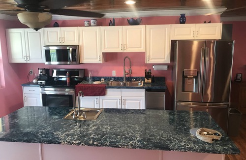 Port Royal House | NEW RENTAL! Conch Heaven is a four bedroom house on a canal with a dock.