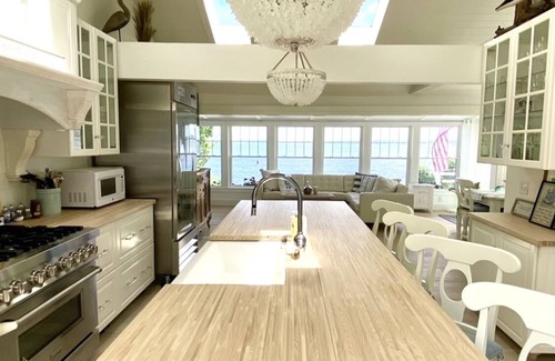Bristol Cottage | Old fashioned designer front porch living by the sea with expansive water views.