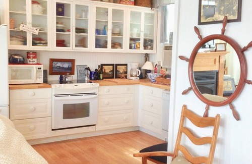 Bristol Cottage | Old fashioned designer front porch living by the sea with expansive water views.