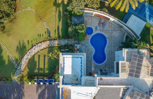 Nagaon Villa | Our Beloved Summer by StayVista - Offering a swimming pool, expansive lawn, badminton court and indoor games