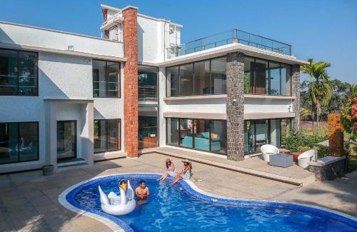 Nagaon Villa | Our Beloved Summer by StayVista - Offering a swimming pool, expansive lawn, badminton court and indoor games