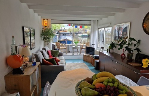 Grachtengordel-West Boat Rental | Pantheos Houseboat in Prinsengracht with a view of the Westerkerk the Landmark.