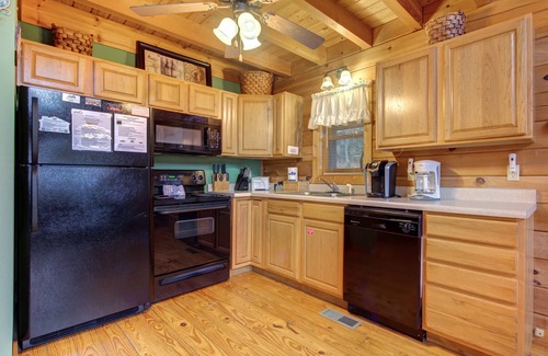 Gatlinburg - Pigeon Forge Cabin | Pet-friendly retreat with tree-top views, a hot tub + an arcade loft!