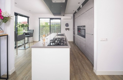 Zeewolde House | Private Finnish sauna, Luxury kitchen with bean coffee maker and large gas stove, With swimming jetty on the water.