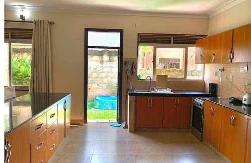 Kampala House | Quiet and peaceful hidden gem surrounded by lush greenery and vibrant flowers.n