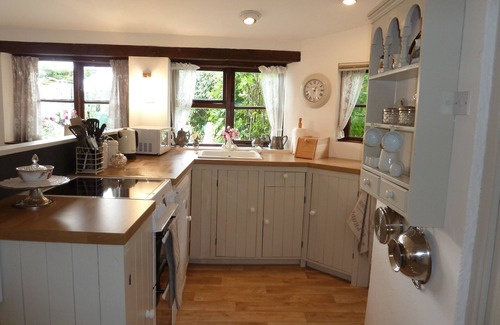 St Issey Cottage | Quirky home with romantic shepherds' hut bedrooms and pretty garden near Padstow