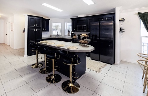 Weeki Wachee Gardens House | River home with huge arcade, hot tub kayaks, mini golf and floating pad, 80in TV