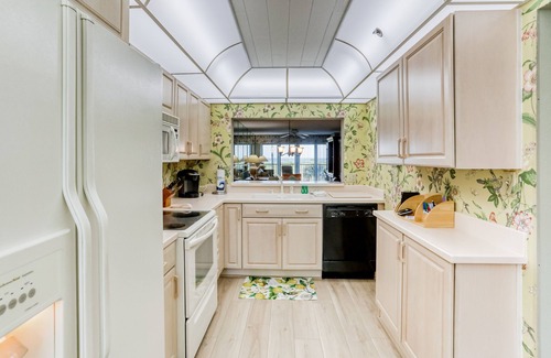 Sand Key House | Second-floor condo with pool and tennis court, private W/D, and central AC