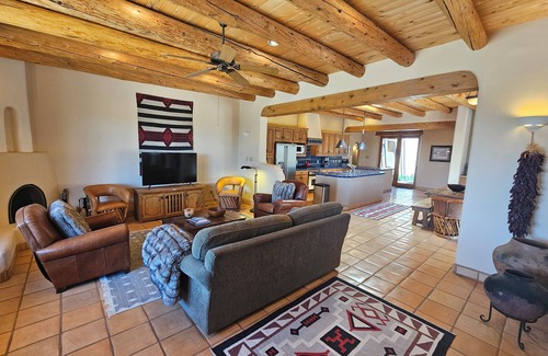 Arroyo Seco House | Sweeping panoramic mountain views, expansive adobe privacy wall system