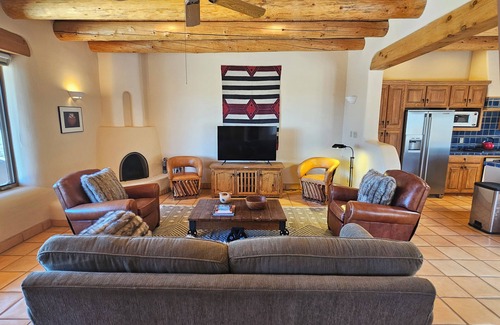 Arroyo Seco House | Sweeping panoramic mountain views, expansive adobe privacy wall system