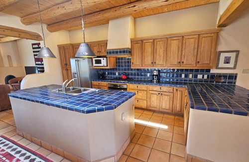 Arroyo Seco House | Sweeping panoramic mountain views, expansive adobe privacy wall system