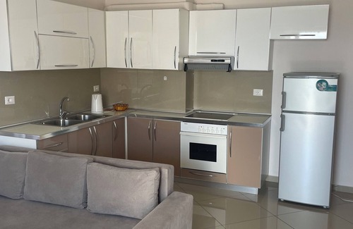 Sarande Apartment | The apartment has a beautiful view of the city and the sea with a balcony.